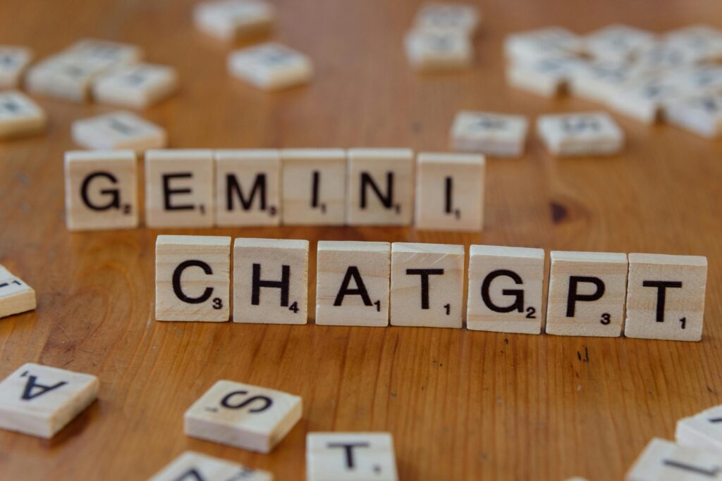 pexels-photo-30869073-30869073 Close-up of wooden Scrabble tiles spelling Gemini and ChatGPT on a wooden surface.